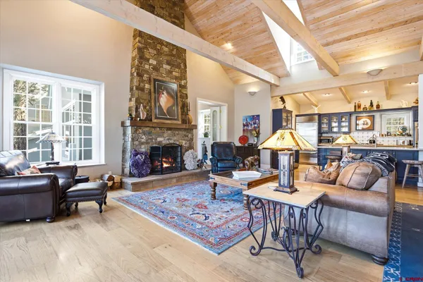 a living room with furniture a fireplace and a table