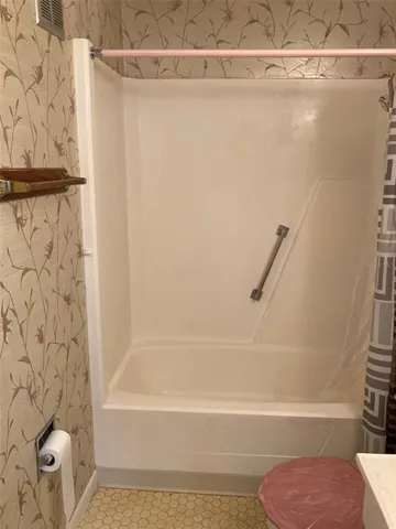 an empty room with windows and entrance