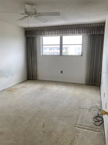 an empty room with a ceiling fan