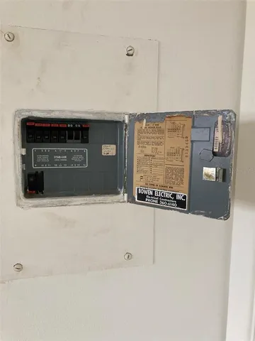 an aerial view of residential houses with outdoor space and a lake view