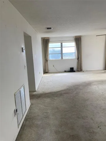 a view of an empty room with a fireplace