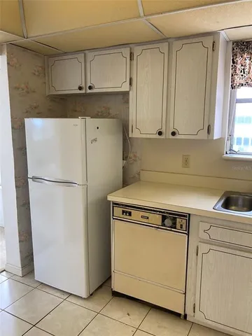 a kitchen with cabinets and a stove top oven