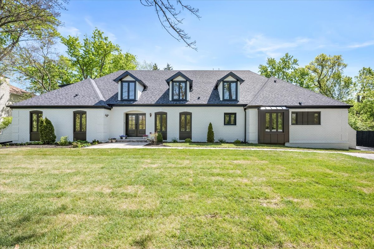 1975 Sunset Ridge Road Northfield, IL 60093 - Photo 1 of 53 front view of a house with a garden