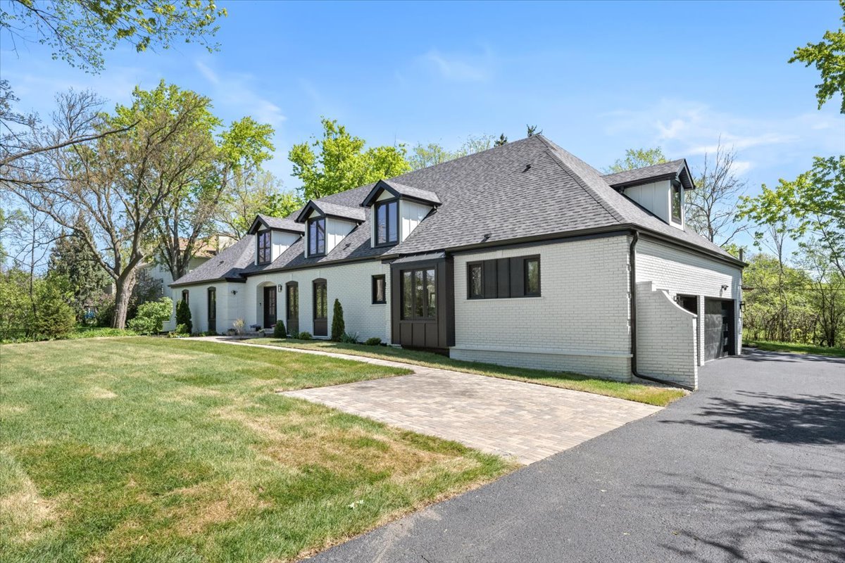 1975 Sunset Ridge Road Northfield, IL 60093 - Photo 2 of 53 a front view of a house with a yard and garage