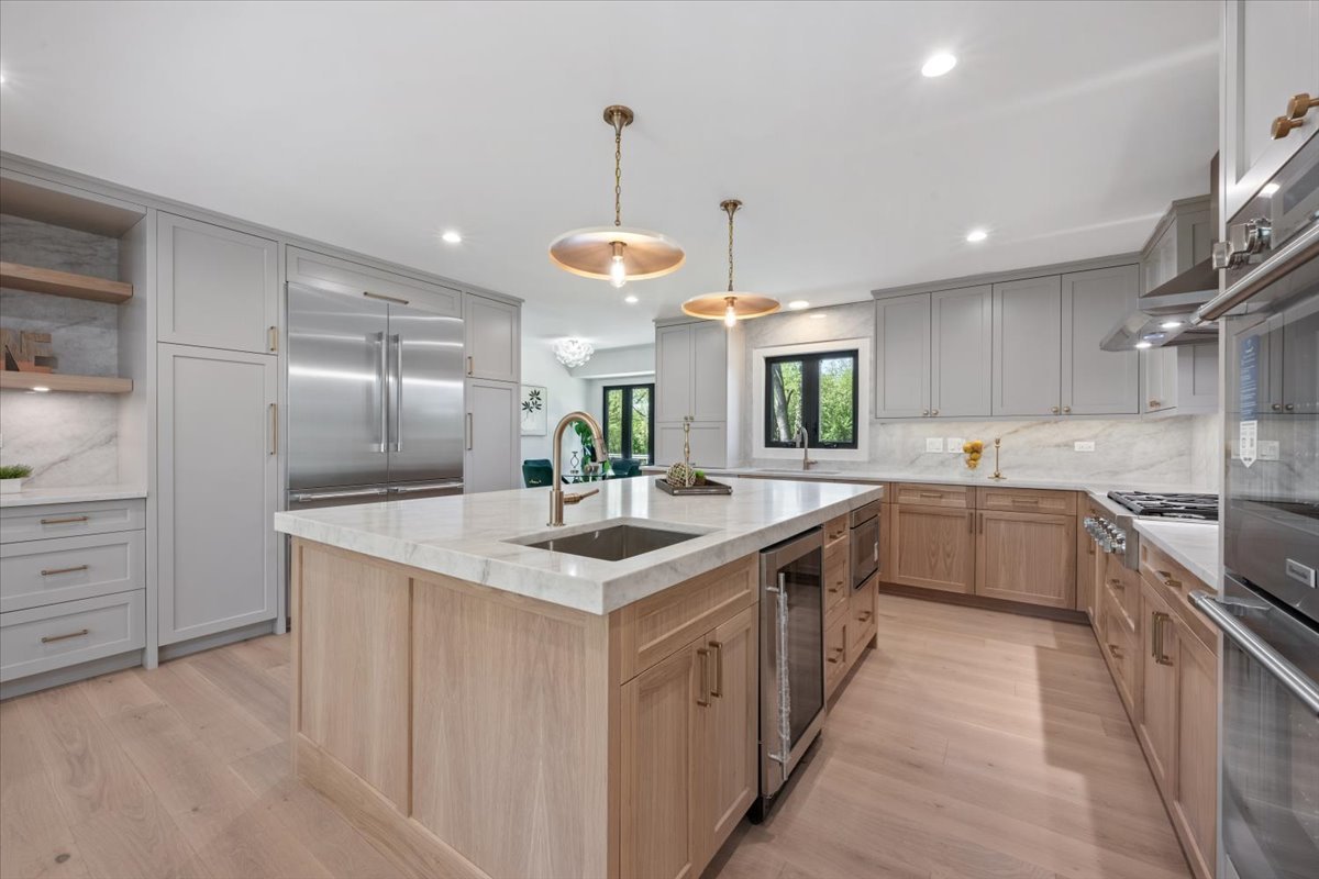 1975 Sunset Ridge Road Northfield, IL 60093 - Photo 21 of 53 a large kitchen with stainless steel appliances kitchen island granite countertop a sink and cabinets