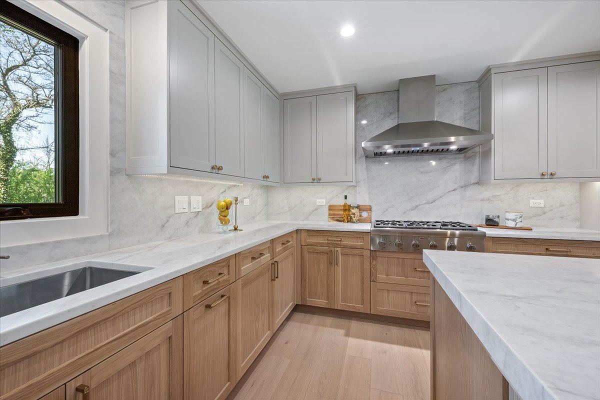 1975 Sunset Ridge Road Northfield, IL 60093 - Photo 23 of 53 a kitchen with granite countertop white cabinets and white appliances