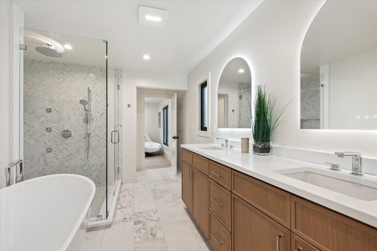 1975 Sunset Ridge Road Northfield, IL 60093 - Photo 29 of 53 a spacious bathroom with a double vanity sink toilet mirror and bathtub
