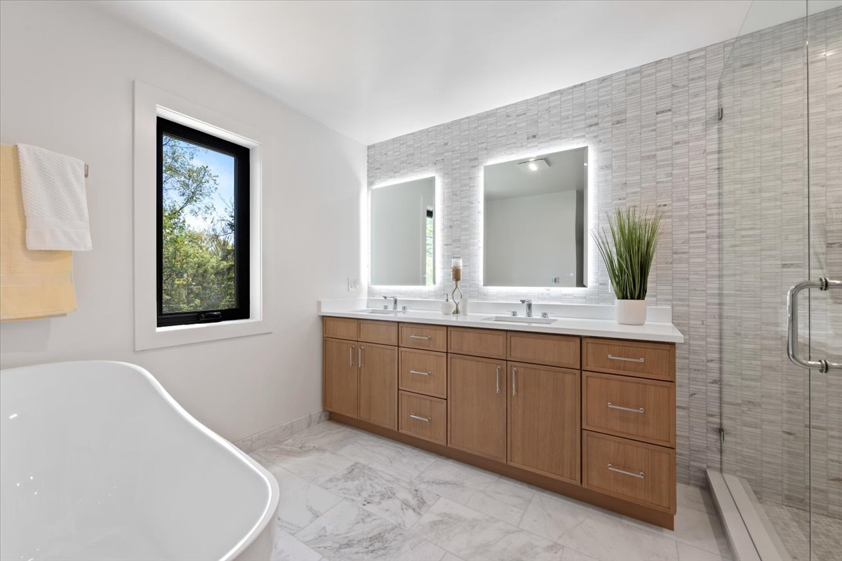 1975 Sunset Ridge Road Northfield, IL 60093 - Photo 42 of 53 a spacious bathroom with a granite countertop sink and a mirror