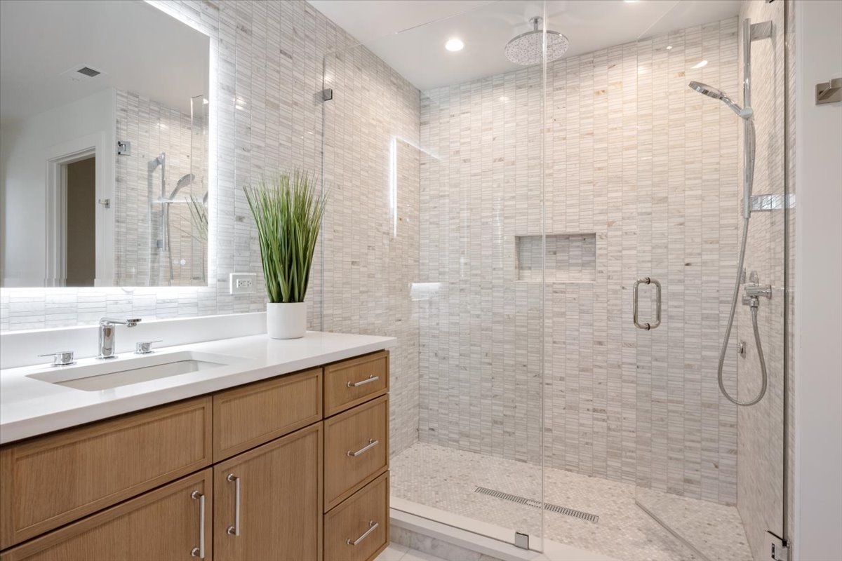 1975 Sunset Ridge Road Northfield, IL 60093 - Photo 43 of 53 a bathroom with a granite countertop sink a shower and a mirror