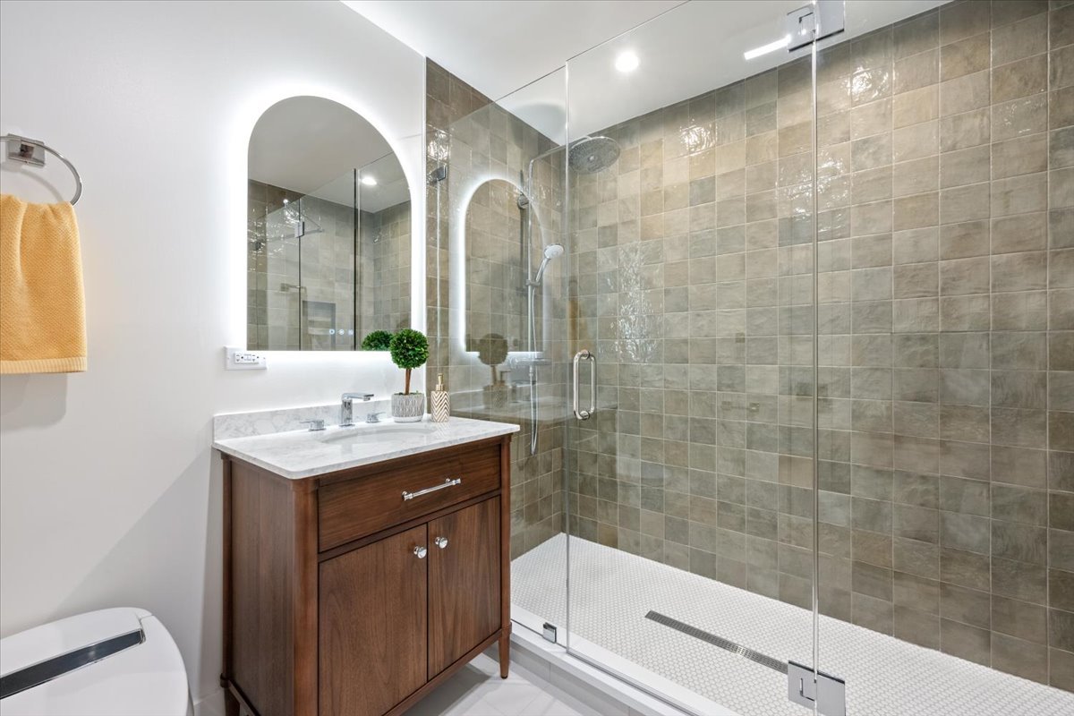 1975 Sunset Ridge Road Northfield, IL 60093 - Photo 45 of 53 a bathroom with a granite countertop sink a toilet a mirror and shower