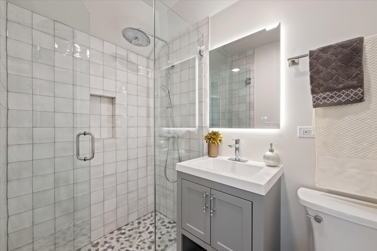1975 Sunset Ridge Road Northfield, IL 60093 - Photo 50 of 53 a bathroom with a sink a toilet and shower