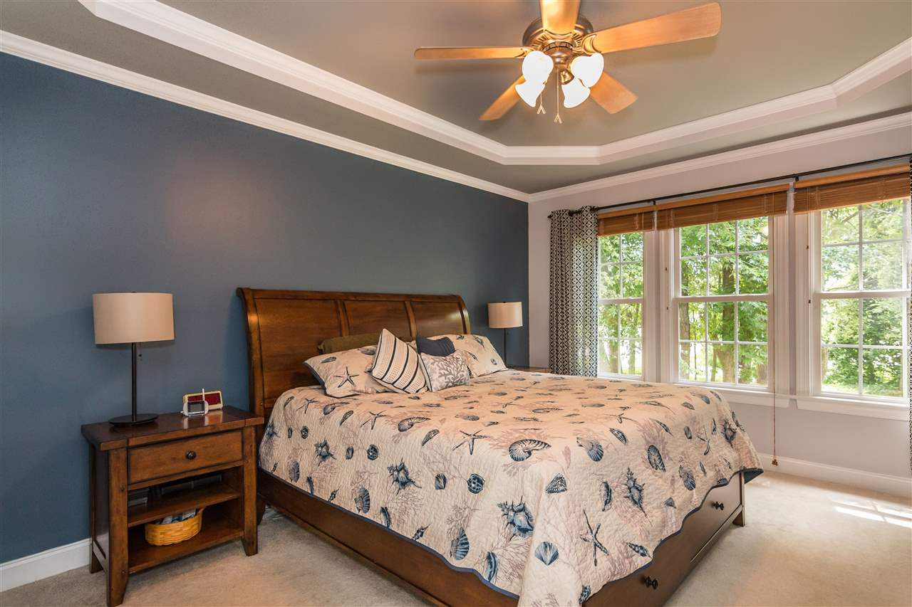 1132 Rhea Drive Garner, NC 27529 - Photo 12 of 25 The spacious first-floor master bedroom features a trey ceiling and beautiful views of the wooded lot - no worries about privacy here! 1st Floor Master bedroom