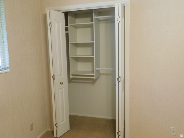 2148 Carolyn Way Bountiful, UT 84010 - Photo 18 of 40 Closet with bi-fold doors, built-in shelving, and hanging rods
