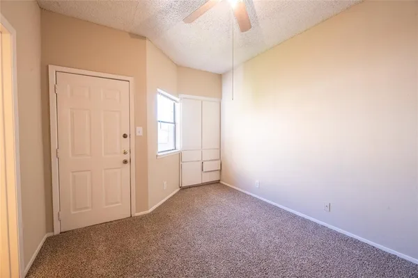 an empty room with a empty space and a ceiling fan