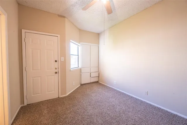 an empty room with a empty space and a ceiling fan