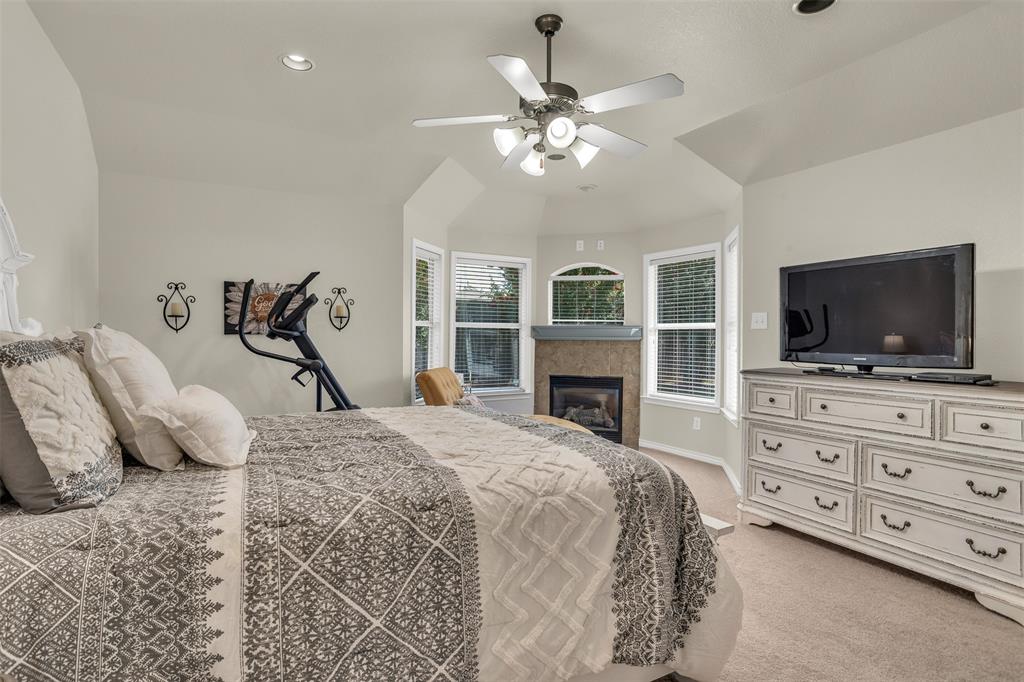 2309 Ranch House Drive Denton, TX 76210 - Photo 14 of 28 a bedroom with a bed and a flat screen tv in it