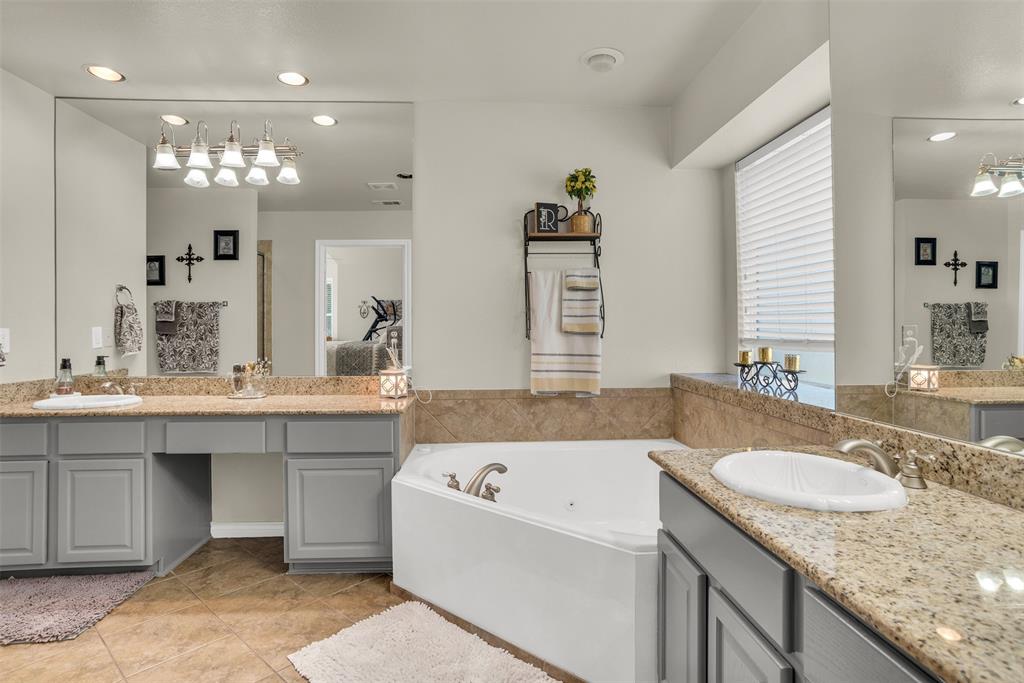 2309 Ranch House Drive Denton, TX 76210 - Photo 15 of 28 a bathroom with a granite countertop tub sink and mirror