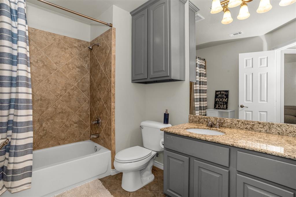 2309 Ranch House Drive Denton, TX 76210 - Photo 17 of 28 a bathroom with a granite countertop sink toilet and shower