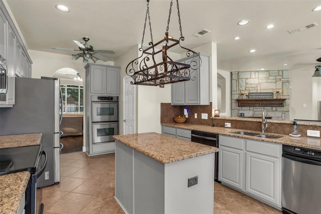 2309 Ranch House Drive Denton, TX 76210 - Photo 2 of 28 a kitchen with stainless steel appliances granite countertop a sink and stove