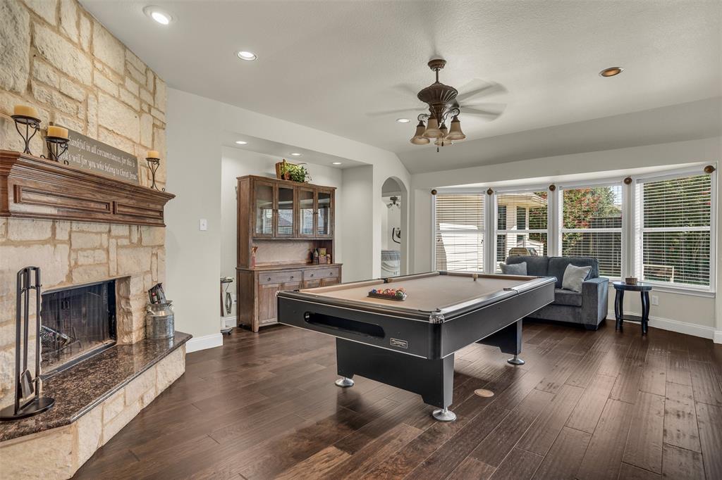 2309 Ranch House Drive Denton, TX 76210 - Photo 3 of 28 a room with furniture pool table wooden floor and a fireplace