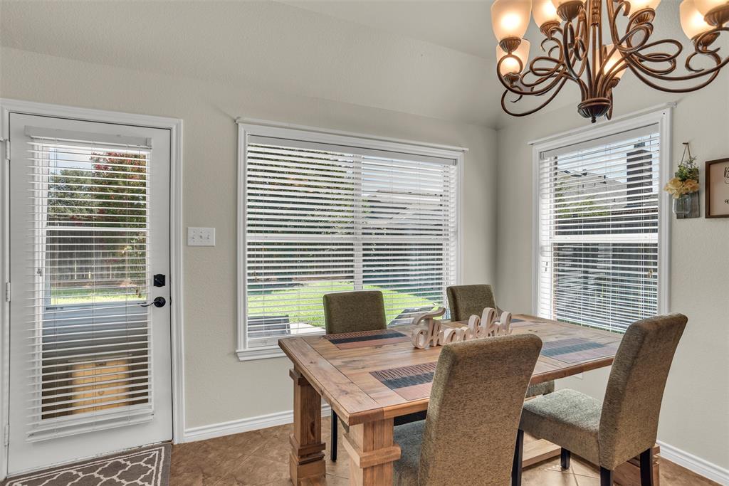 2309 Ranch House Drive Denton, TX 76210 - Photo 10 of 28 a view of a dining room with furniture and windows