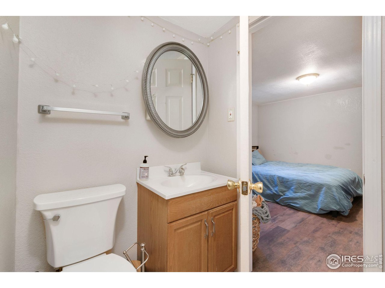 109 3rd Street Pierce, CO 80650 - Photo 14 of 21 a bathroom with a sink a toilet and a mirror