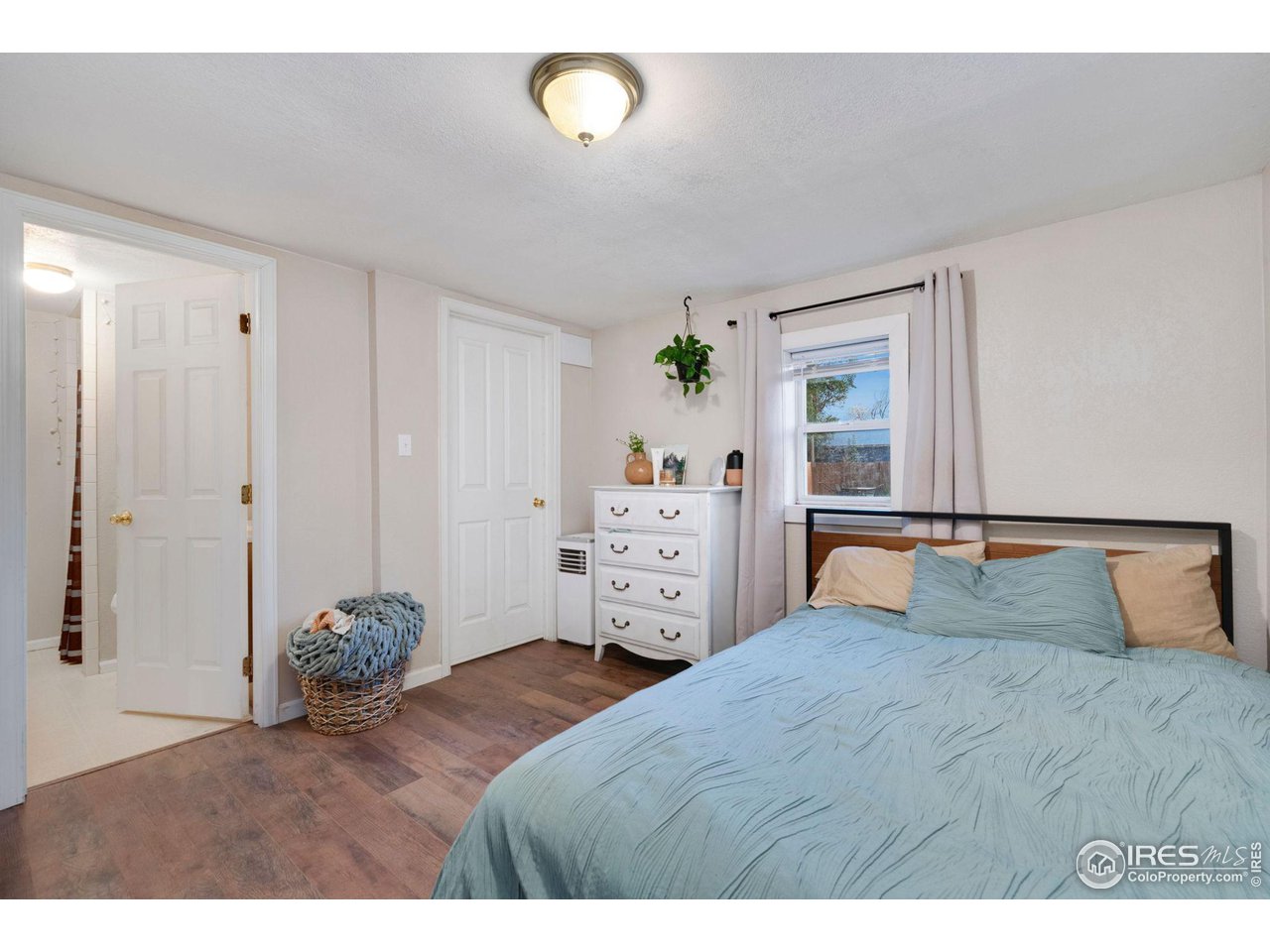 109 3rd Street Pierce, CO 80650 - Photo 15 of 21 a bedroom with a large bed and a dresser