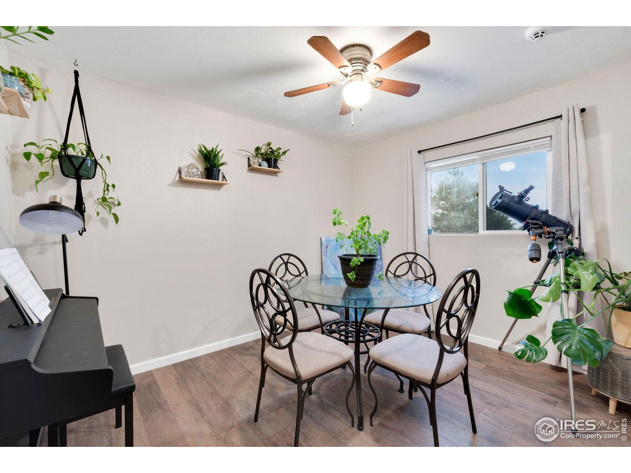 109 3rd Street Pierce, CO 80650 - Photo 6 of 21 a view of a dining room with furniture wooden floor and a chandelier