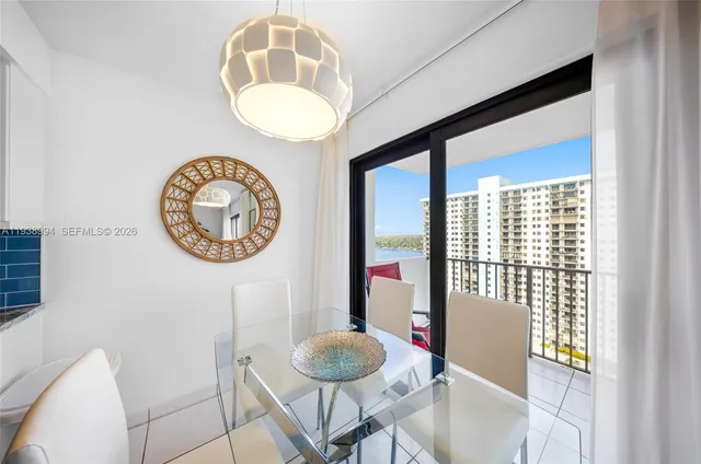 a living room with a table and a mirror