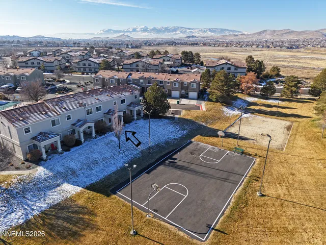 an aerial view of residential houses with outdoor space
