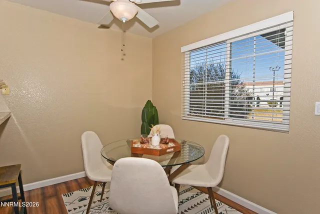 a view of a dining room with furniture and window