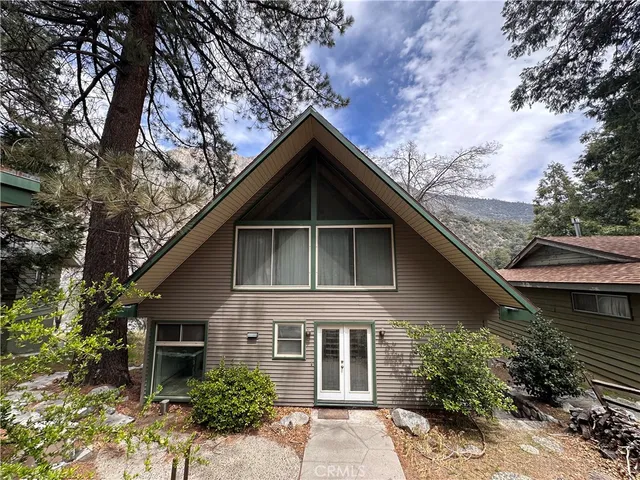a view of a house with a small yard