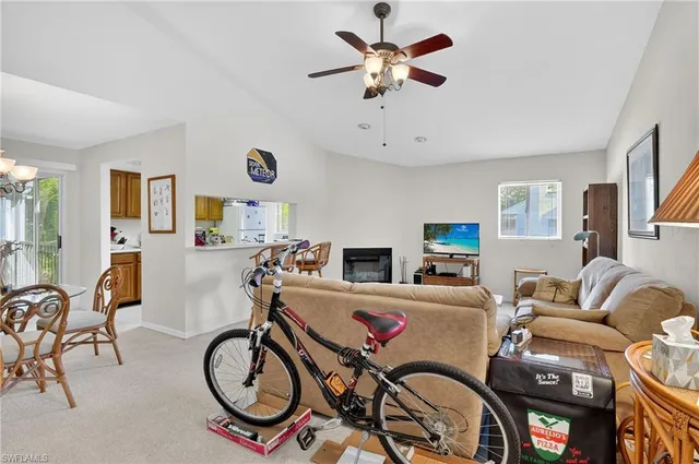 a living room with furniture a flat screen tv and a window
