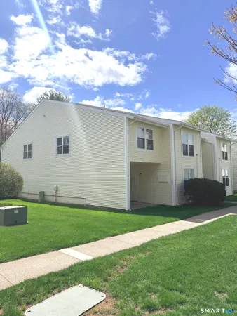 a kitchen with a refrigerator sink and cabinets