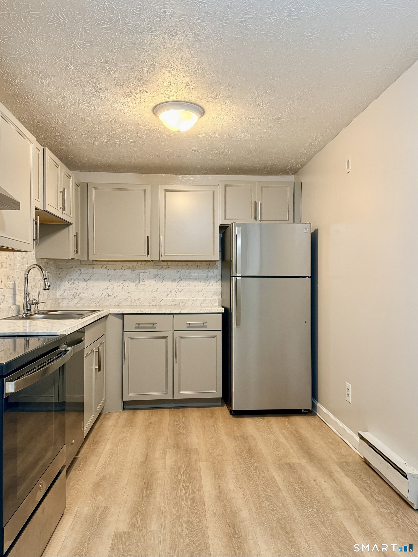801 Pleasant Valley Road, Unit 801 South Windsor, CT 06074 - Photo 5 of 12 a kitchen with a refrigerator sink and cabinets