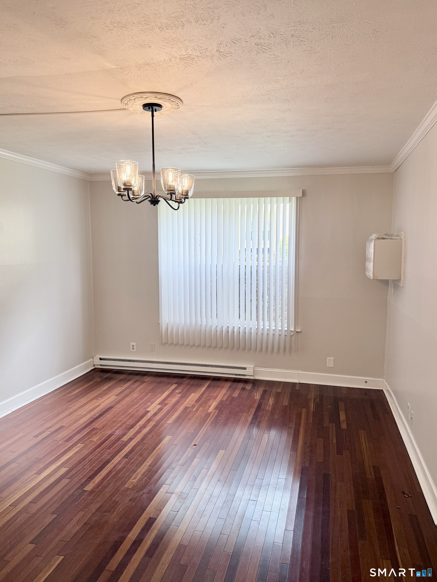 801 Pleasant Valley Road, Unit 801 South Windsor, CT 06074 - Photo 7 of 12 a view of an empty room with wooden floor and a window