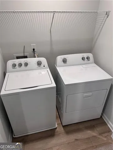 a white toilet and tub sitting next to a bathroom sink