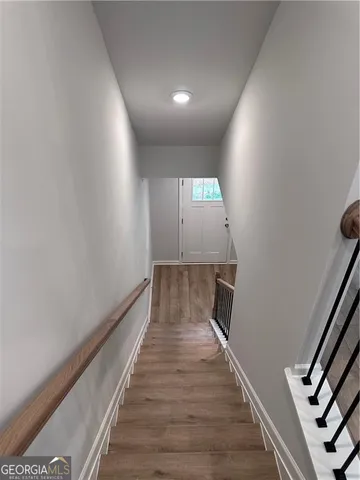 a kitchen with white cabinets and black appliances