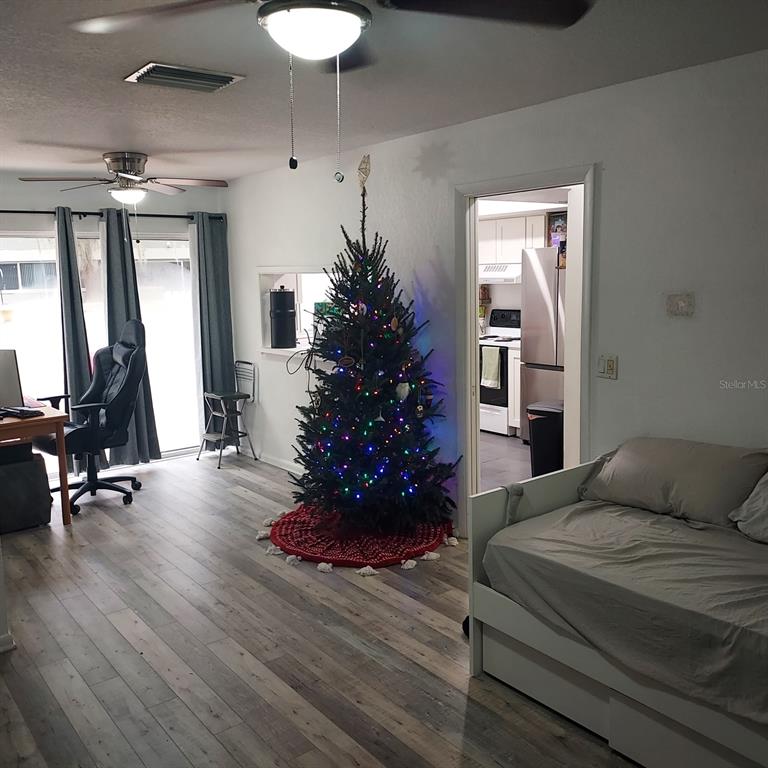 6257 Dewdrop Way, Unit 6257 Temple Terrace, FL 33617 - Photo 4 of 13 a bedroom with a flower bed and a potted plant