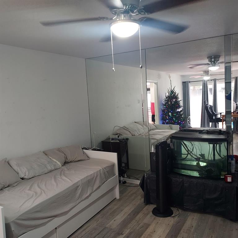 6257 Dewdrop Way, Unit 6257 Temple Terrace, FL 33617 - Photo 5 of 13 a bedroom with a bed and a mirror