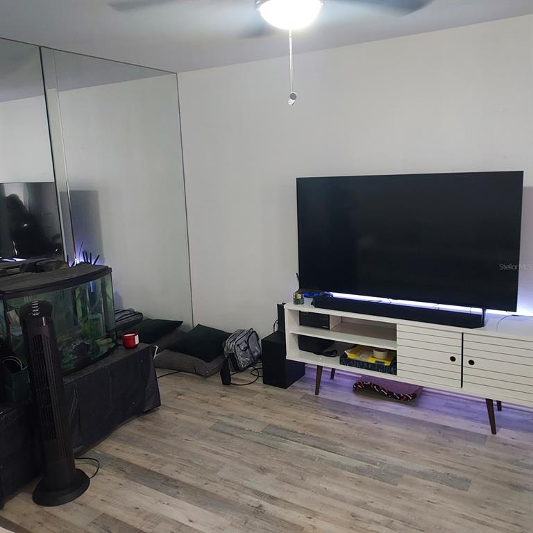 6257 Dewdrop Way, Unit 6257 Temple Terrace, FL 33617 - Photo 6 of 13 a living room with furniture and a flat screen tv