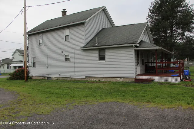 a front view of a house with a garden and deck