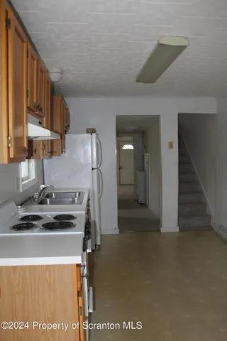 a kitchen with stainless steel appliances granite countertop a stove and a refrigerator