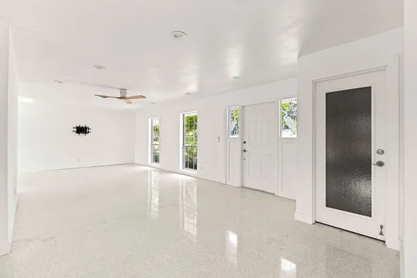 an empty room with windows and entrance