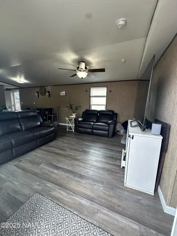 a view of living room with furniture and a flat screen tv