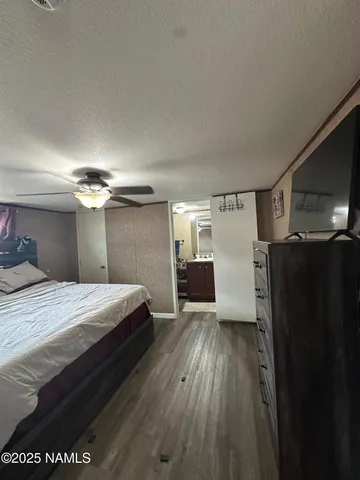 a room with a bed and a ceiling fan