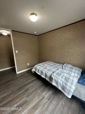 a bedroom with a bed and a night stand