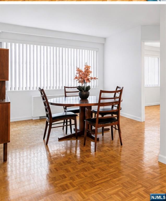 1375 River Road, Unit 1K Edgewater, NJ 07020 - Photo 5 of 15 a view of a dining room with furniture and wooden floor