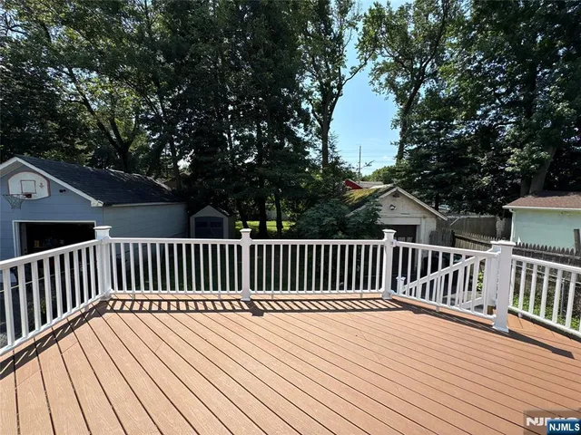 a balcony with wooden floor and fence