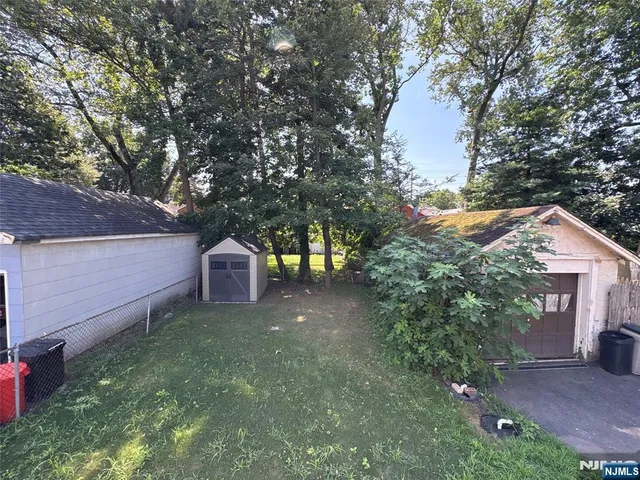a view of a backyard with large trees